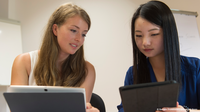 2 female students with notebooks